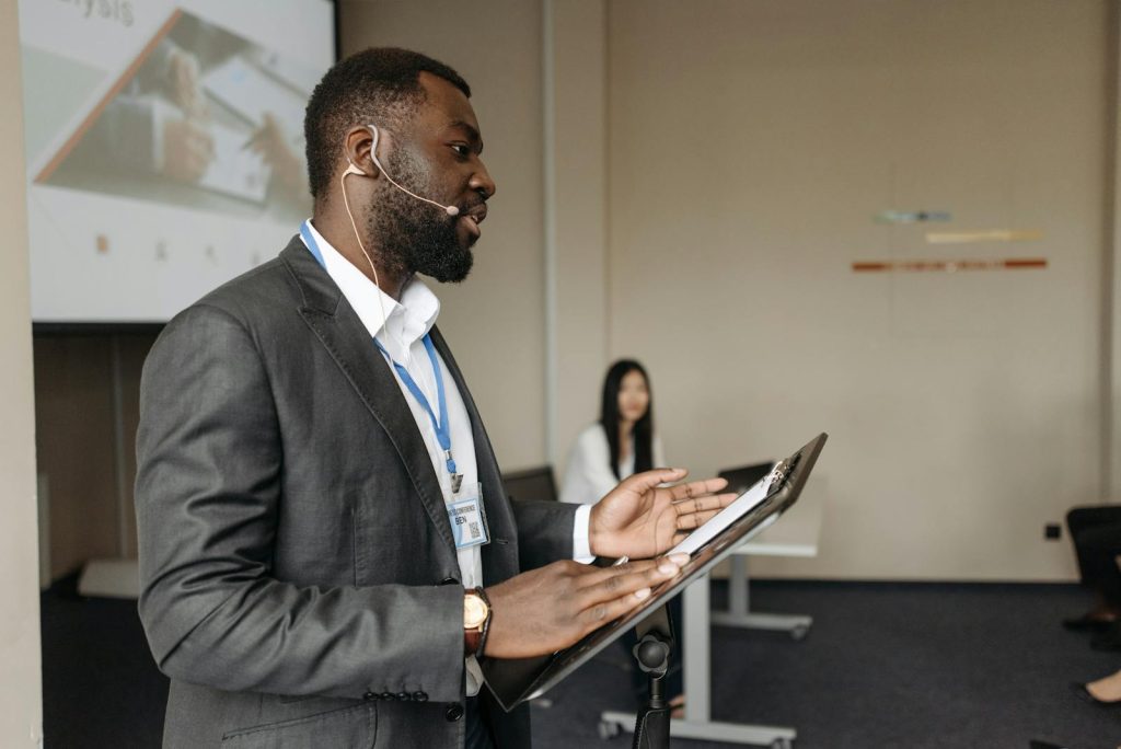 Professional speaker at a business conference presenting with confidence.